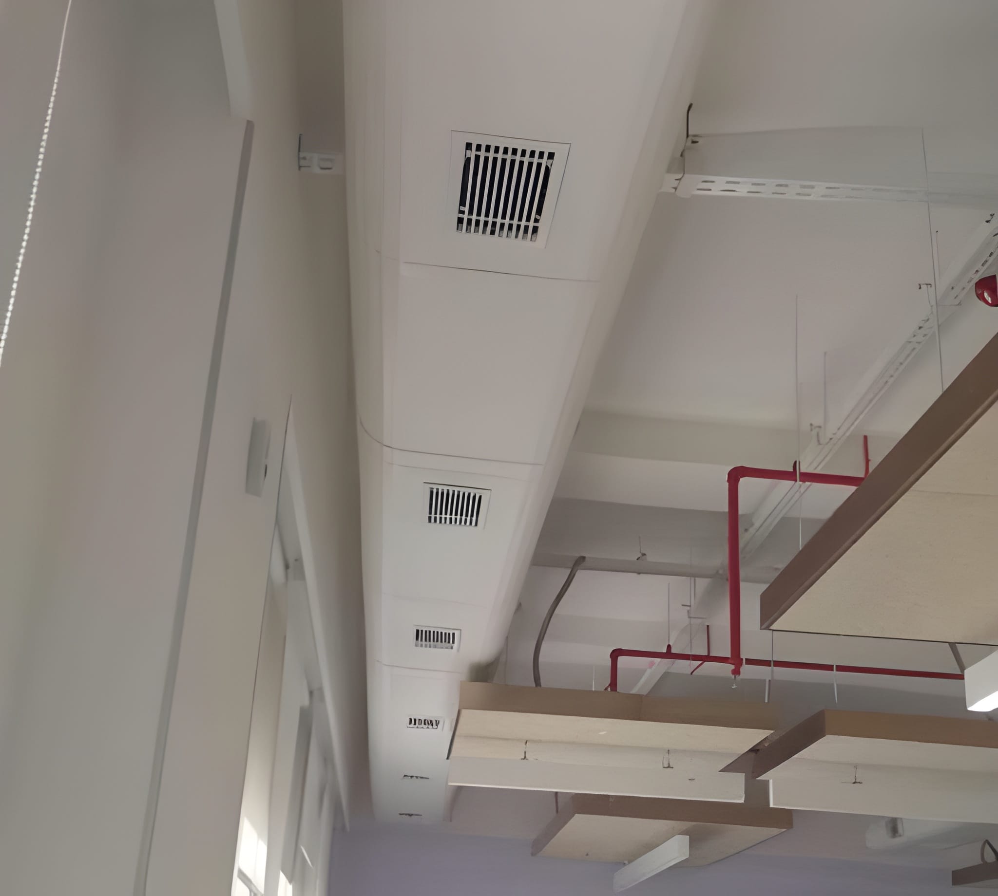 Flush insulated duct run with aligned square ceiling air grilles